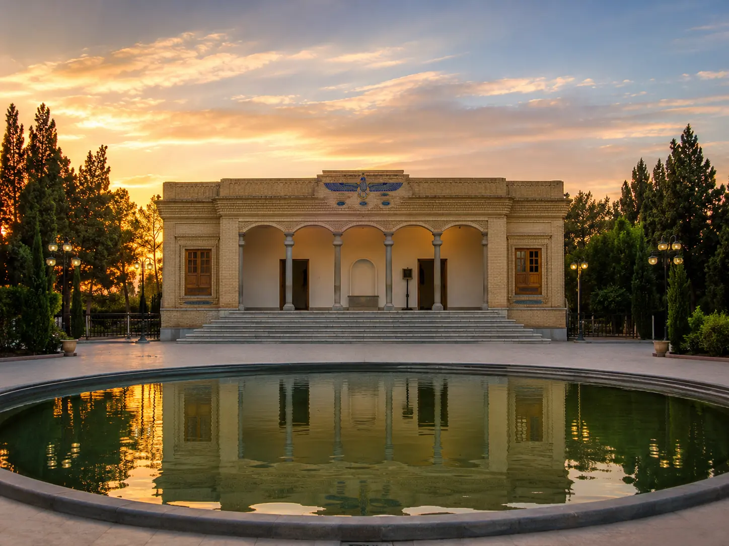 Zoroastrian Fire Temple in Yazd at sunset with pool reflection and garden trees
