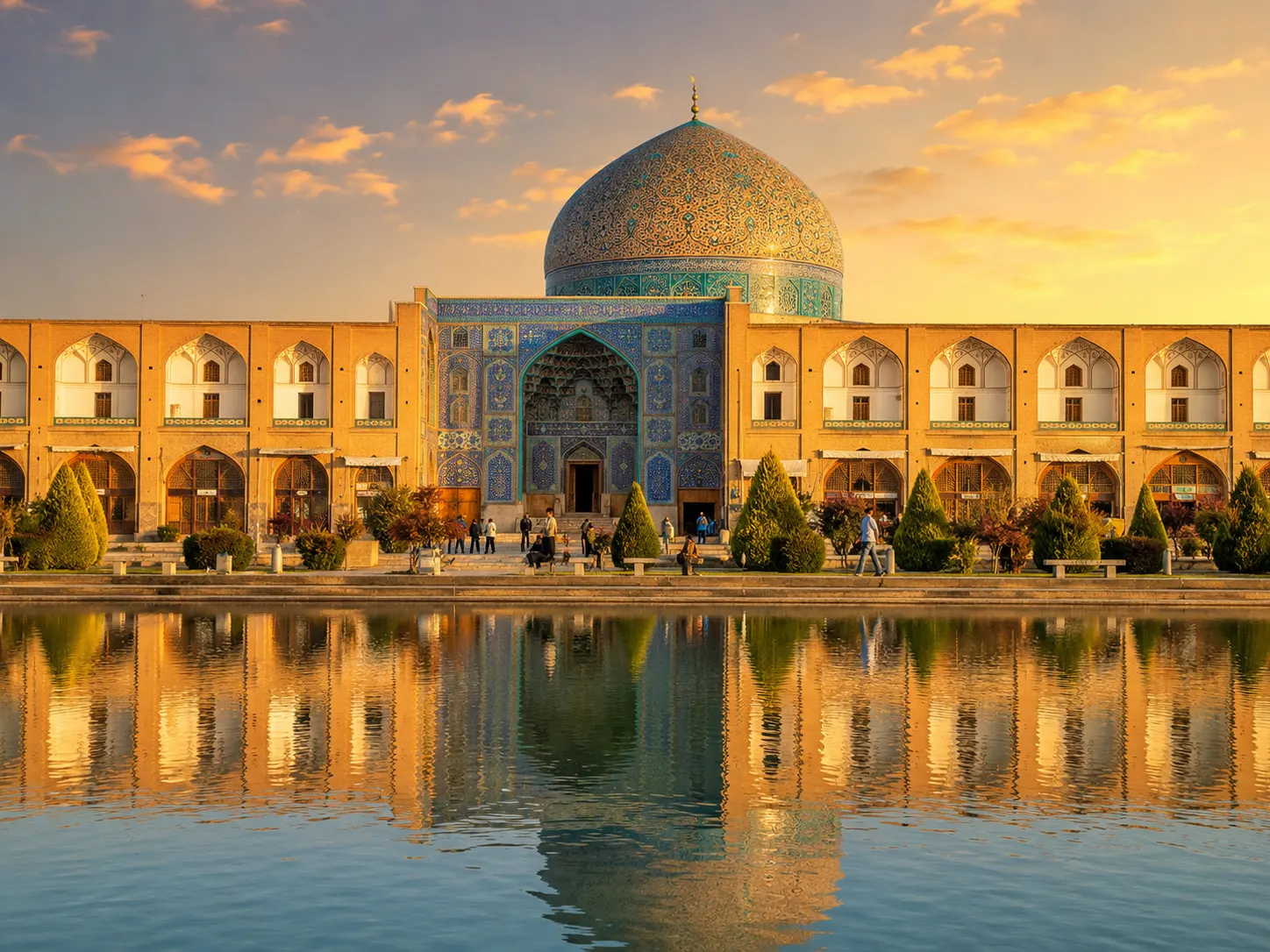 Blue dome of Imam Mosque reflected in water pool at sunset in Isfahan